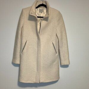 A women’s LOFT bouclé coat in a cream ivory color with a soft, textured “bouclé